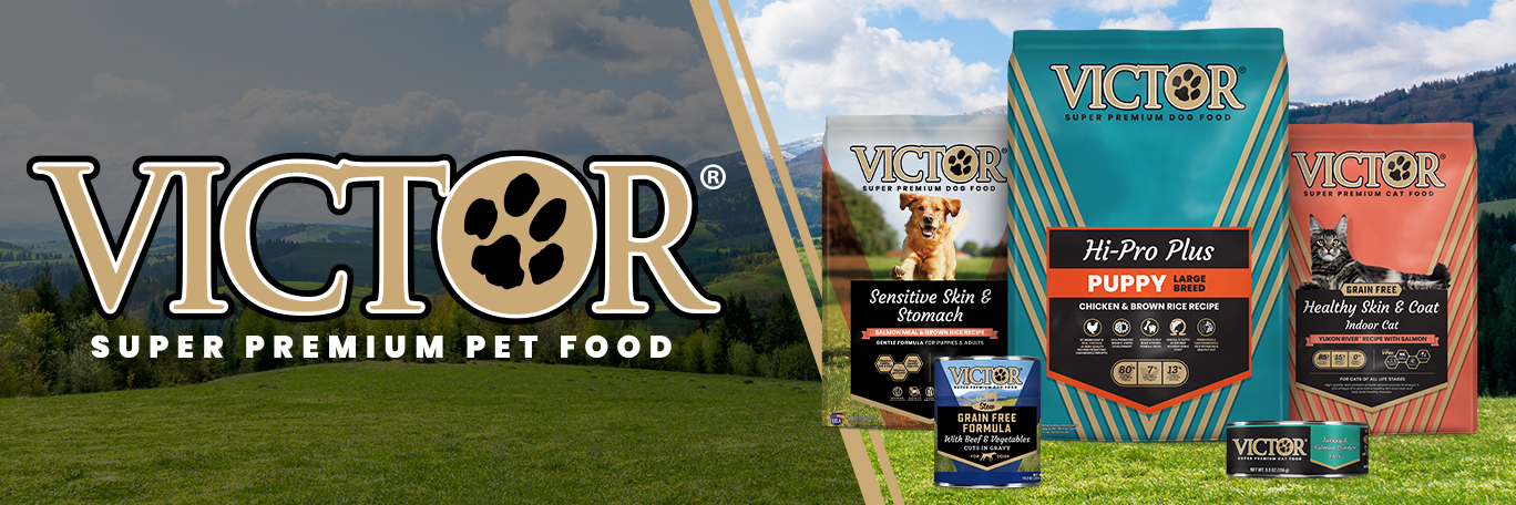 Victor Super Premium Dog Food logo and assorted dog and cat products against outdoor backdrop. 